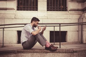 man gambling outdoor by way of mobile gambling app