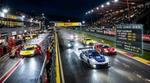 A high-speed motorsport race scene with cars on a track